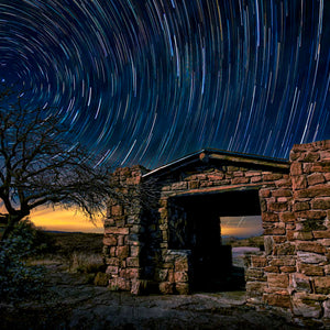 Fort Davis Light Show #1 — star trails over a stone shelter in Davis Mountains State Park, Texas, by Carol Fox Henrichs